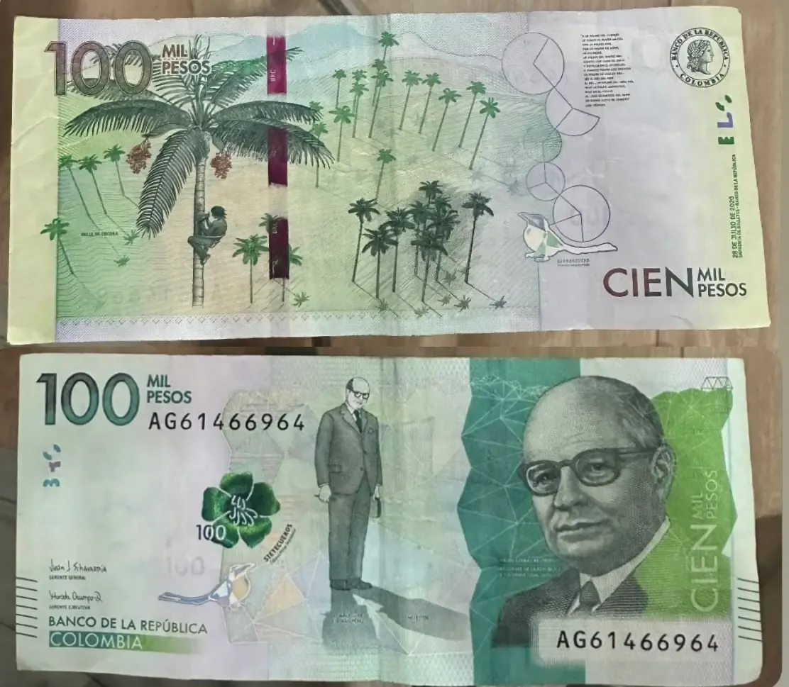100,000 Colombian peso banknote, in lush green, showing Cocora Valley and native flora