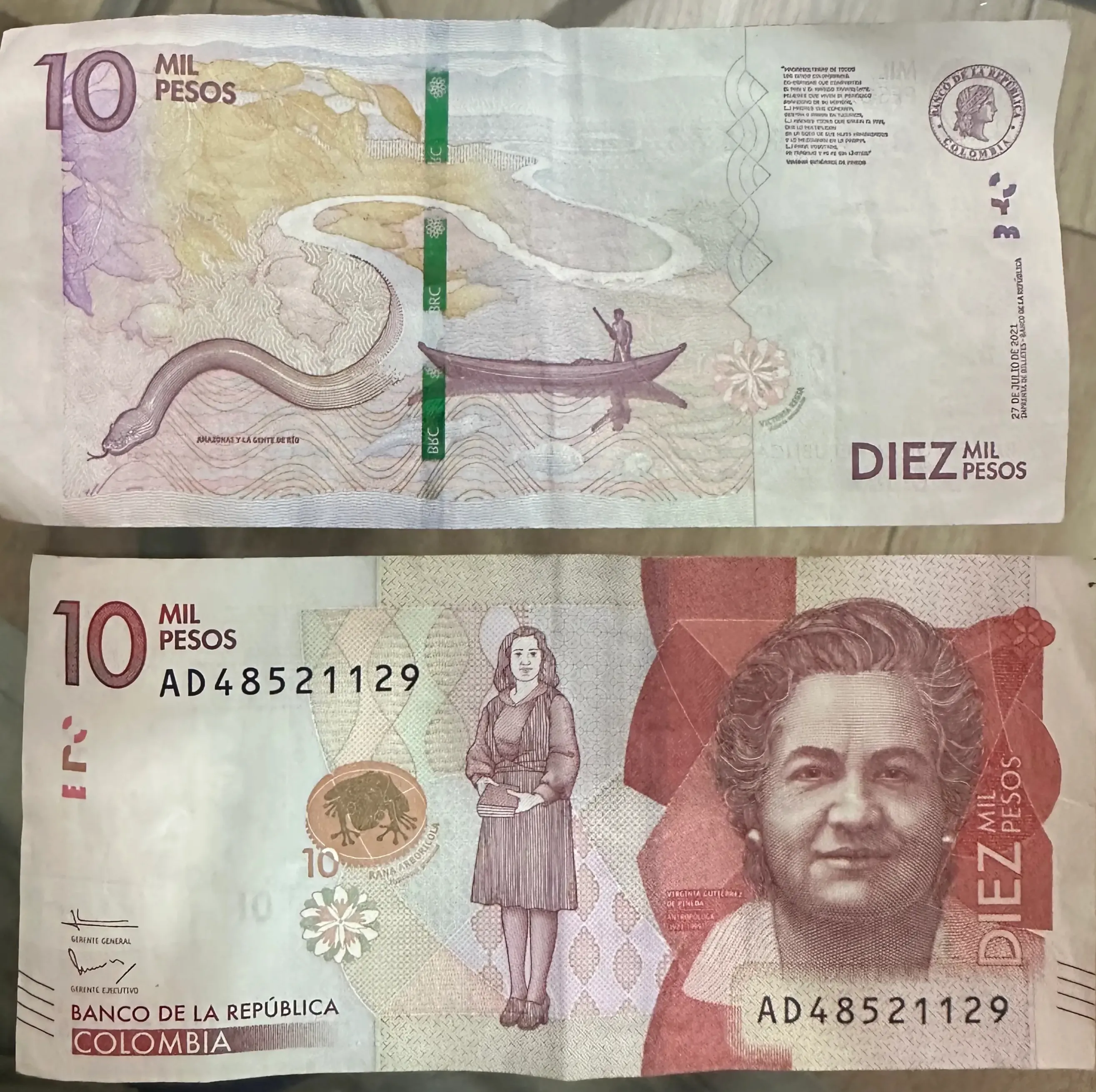 10,000 Colombian peso banknote, in deep red, illustrating the richness of the Amazon
