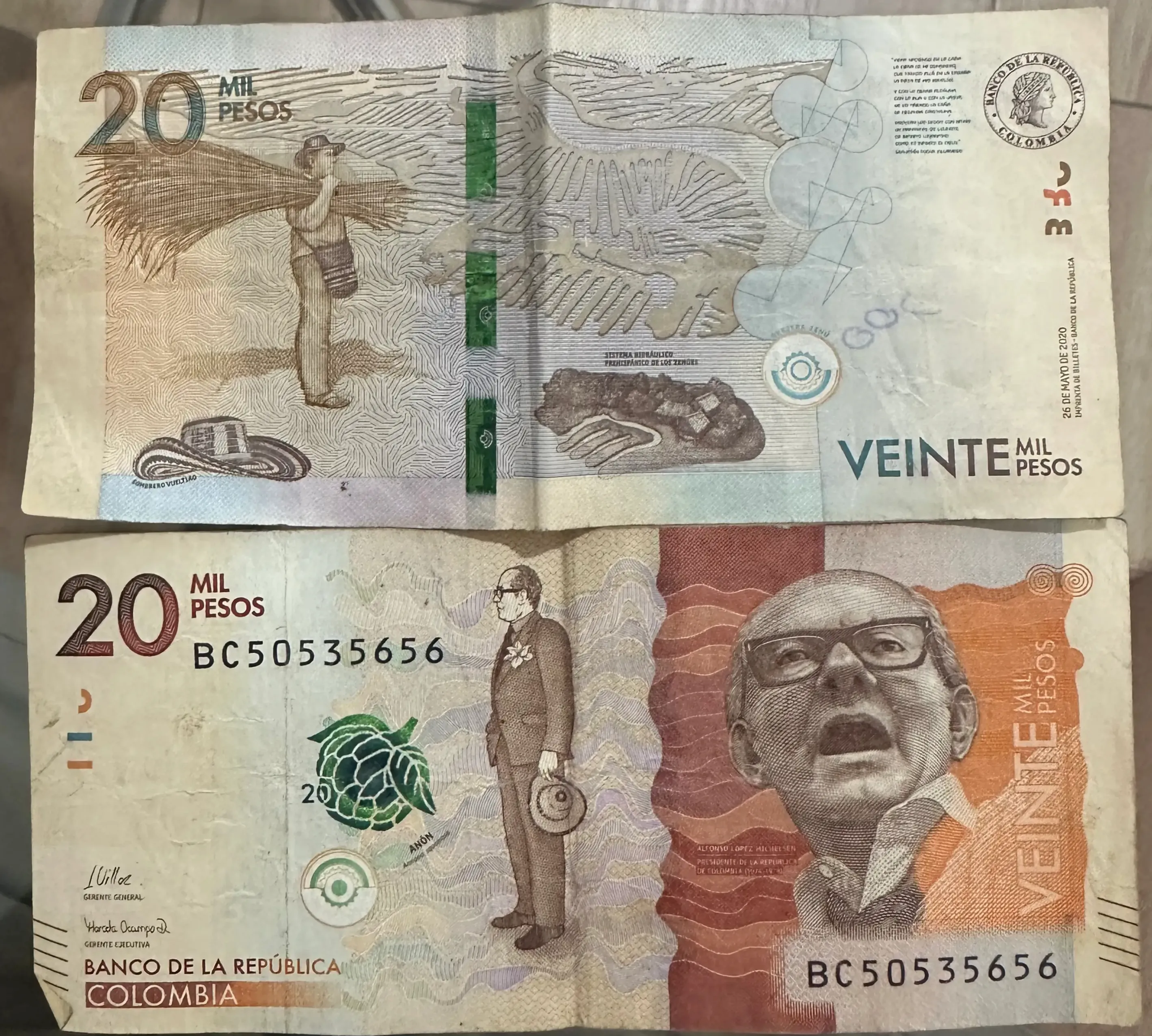 20,000 Colombian peso banknote, with orange tones and cultural Colombian tributes