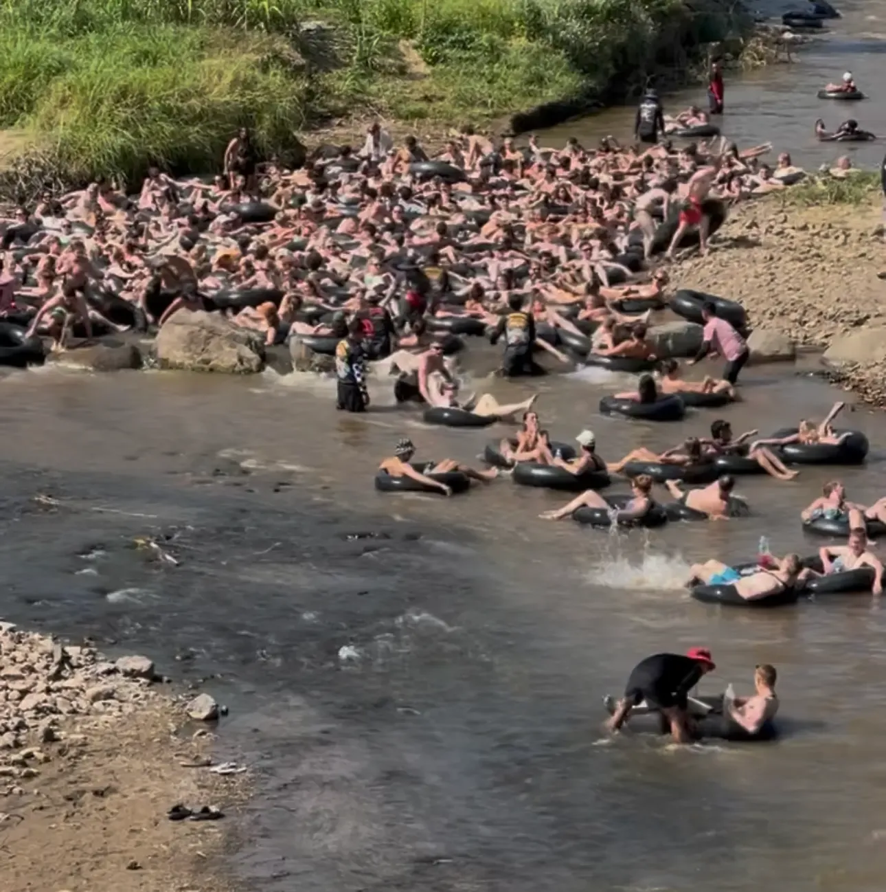 Travelers floating on tubes during Jungle Tubing on the Pai River, Thailand.