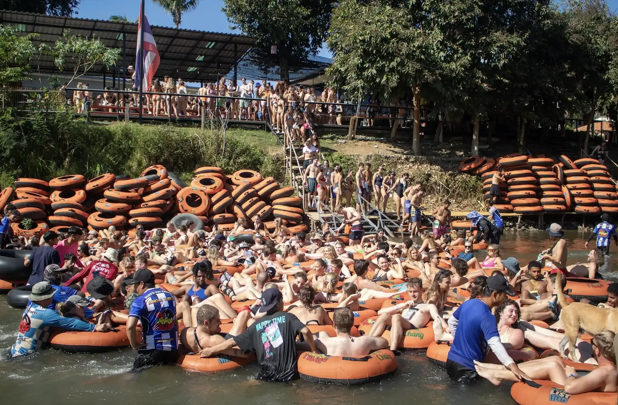 Colorful tubes floating on the Pai River surrounded by Thai jungle
